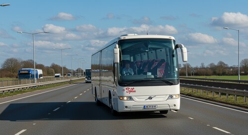 Luxury Airport Express coach driving on M11 motorway towards Stansted Airport with clear blue skies and modern comfortable seating visible